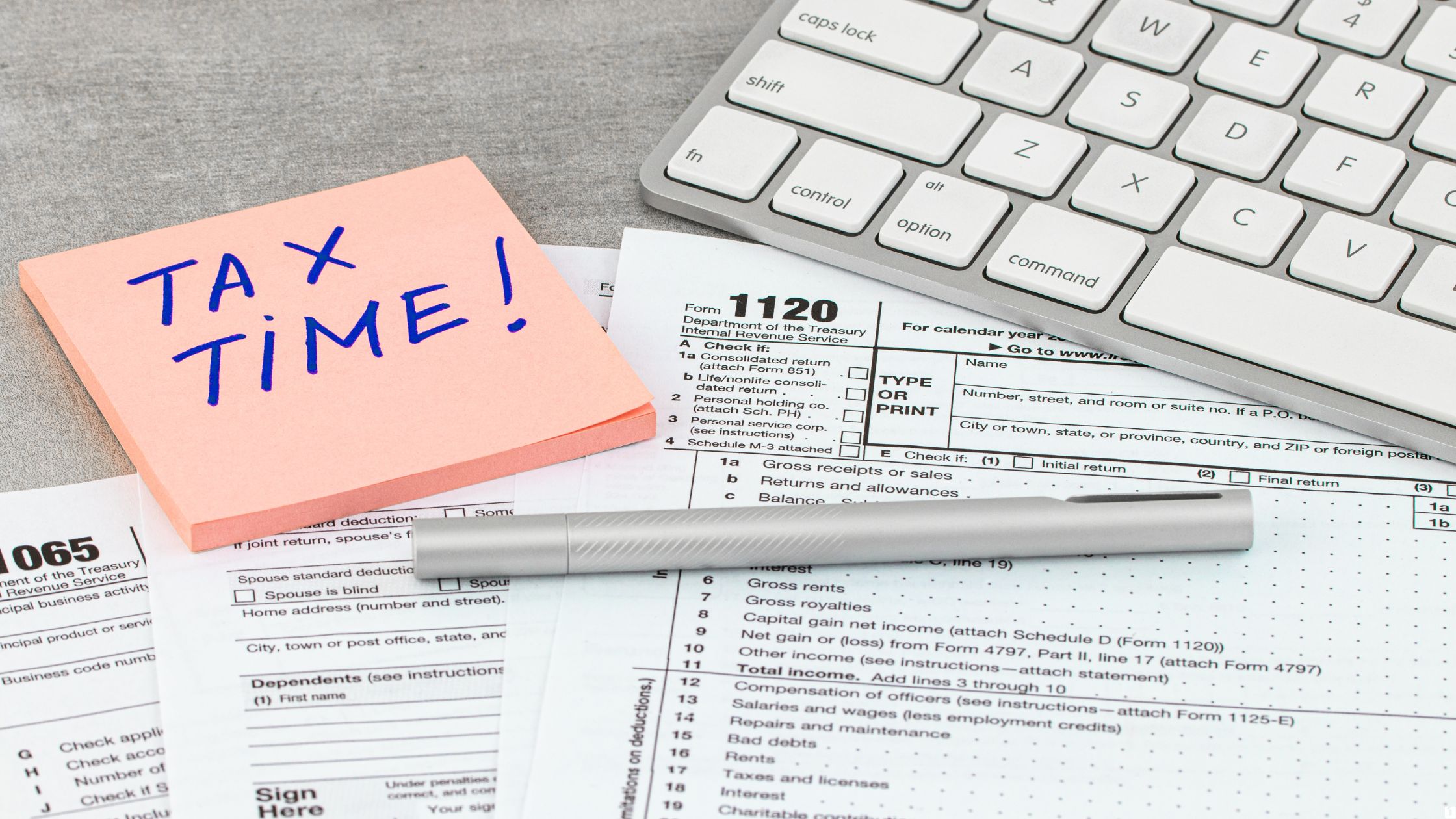 Tax time sticky note reminder placed above tax forms