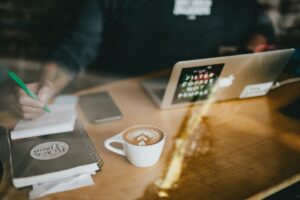 Small business owner reviewing financial records and planning summer business goals