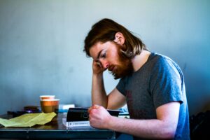 Business owner looking worried while reviewing bills or invoices