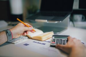 Small business owner checking financial metrics at workspace
