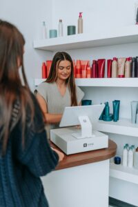 Small business owner using a POS system in a retail shop